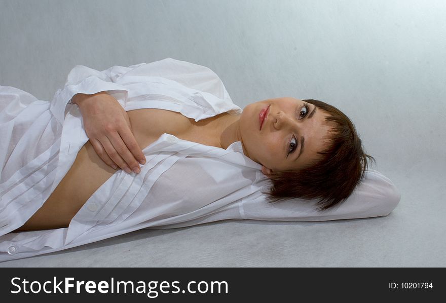 Portrait Of Girl Who Lies In A White Shirt On An