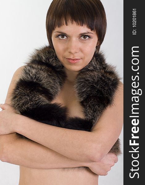 Portrait of a young girl who perky girl hugs herself and holds fur. Portrait of a young girl who perky girl hugs herself and holds fur