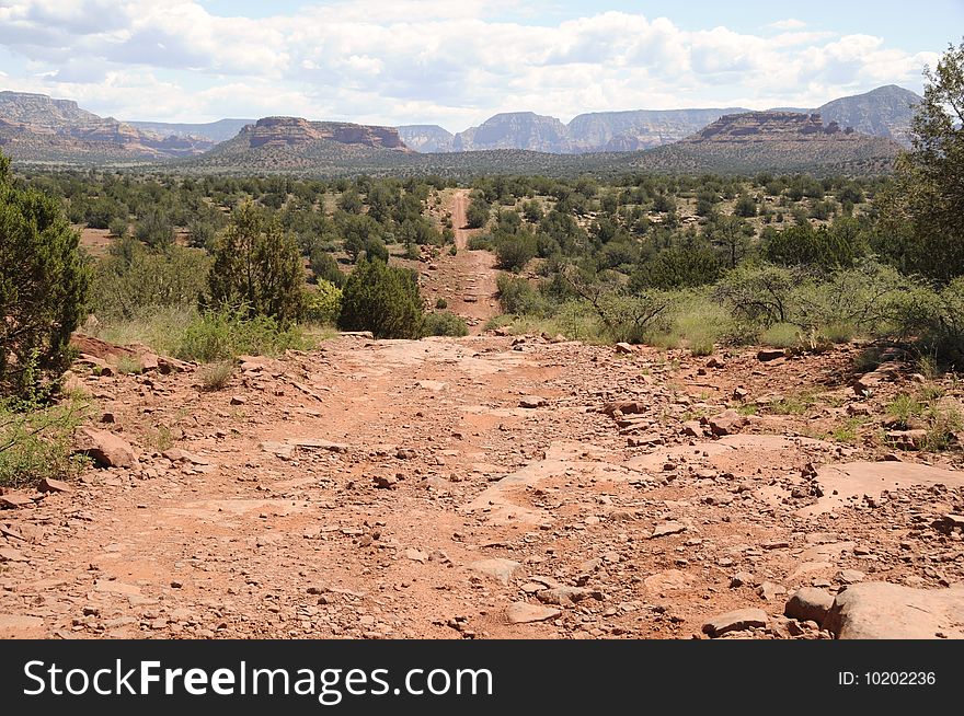 View of offroading desert in Sedona Arizona, red rocks surrounded by scrub brush