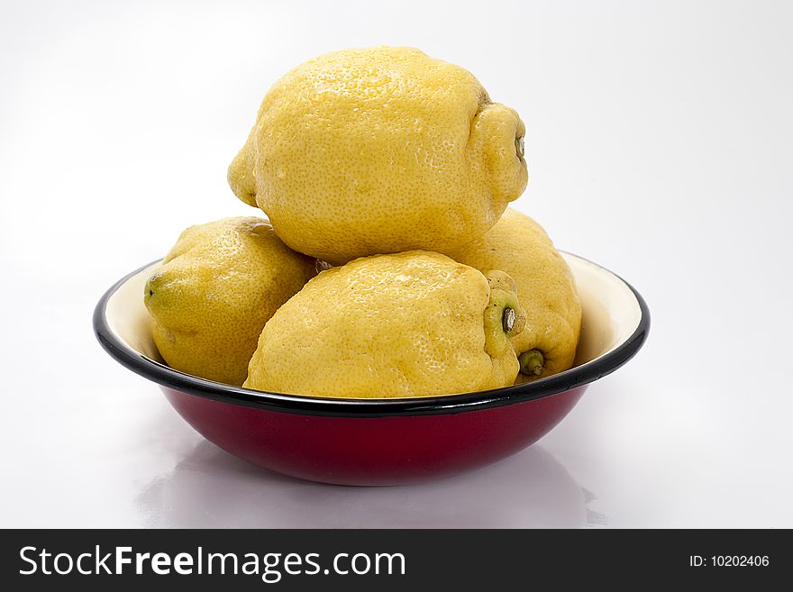 Five lemons in a red bowl. Shallow d o f. Five lemons in a red bowl. Shallow d o f