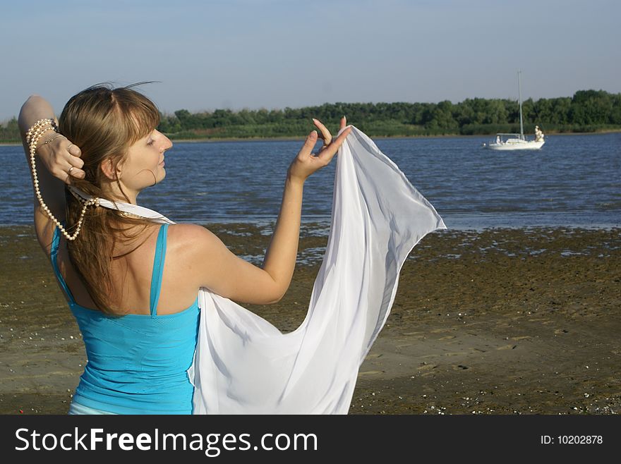 Romantic girl on a bank of the river