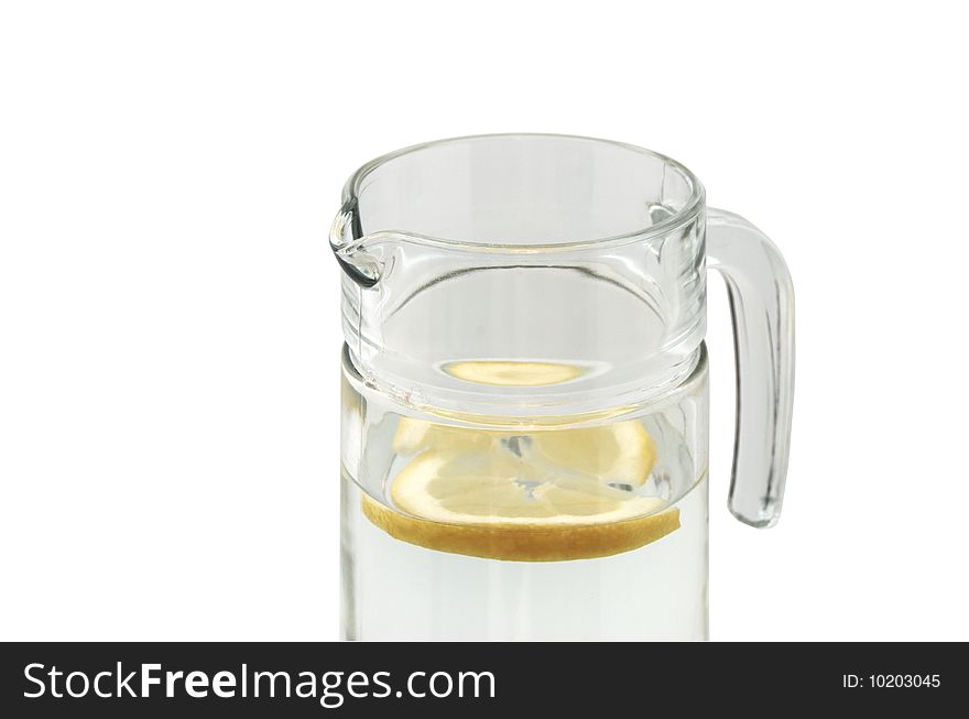 Glass jug with water and lemon