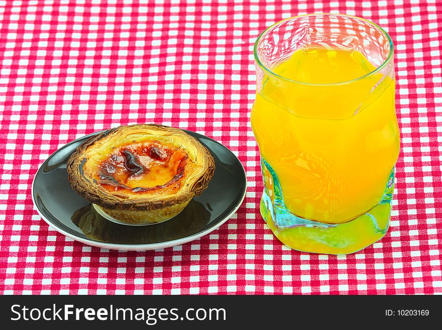 Glass of orange juice and cake