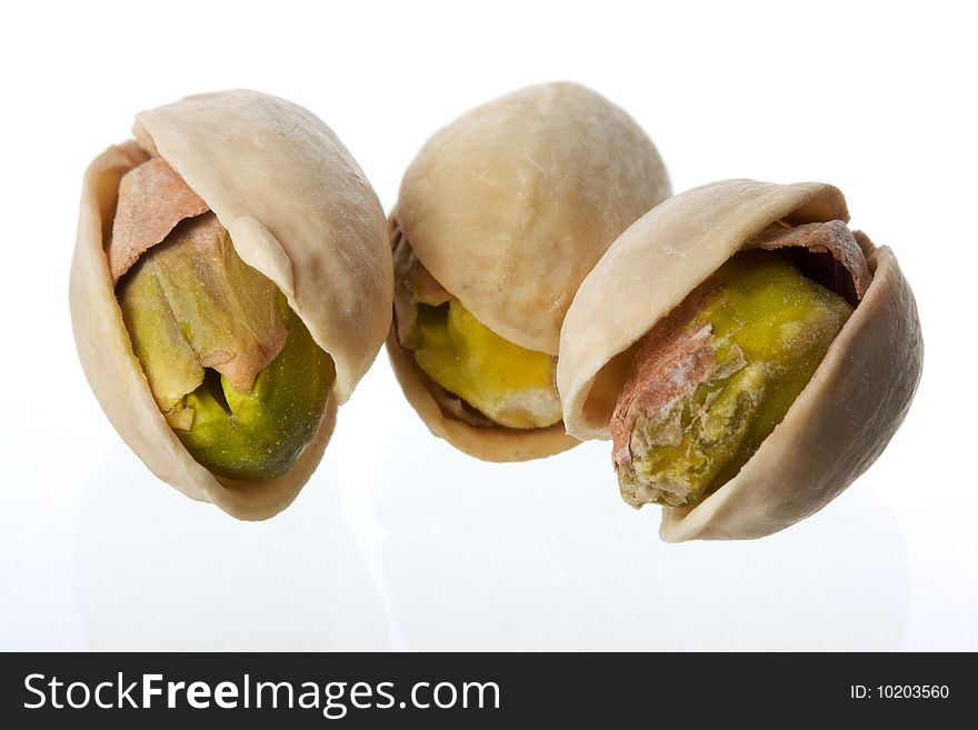 Three pistachios on white background