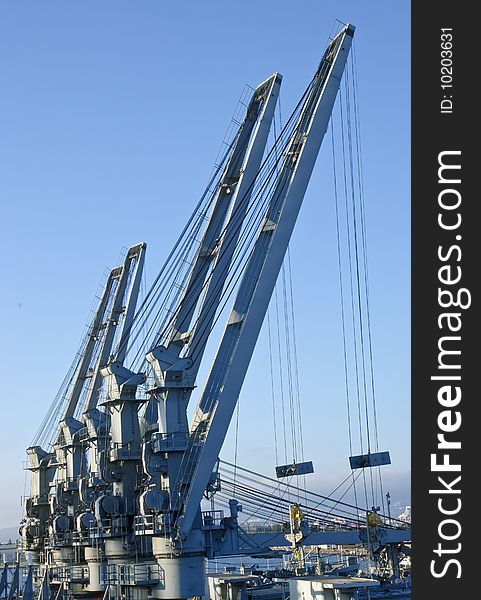 Cranes in dockyard - perspective against blue sky