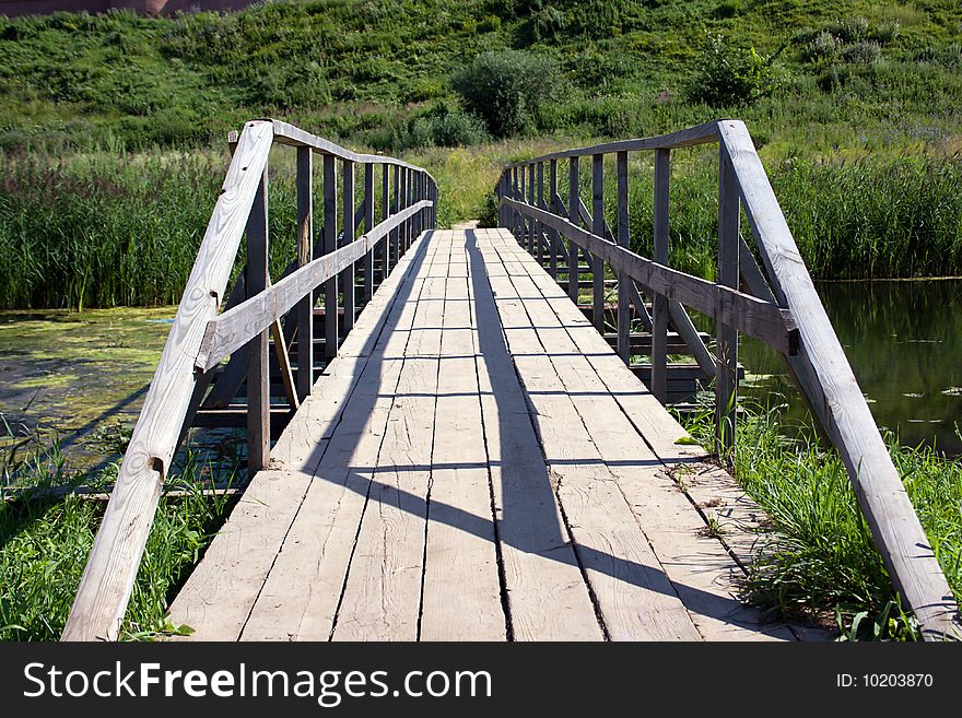 The Bridge Through The River On A Background Of A