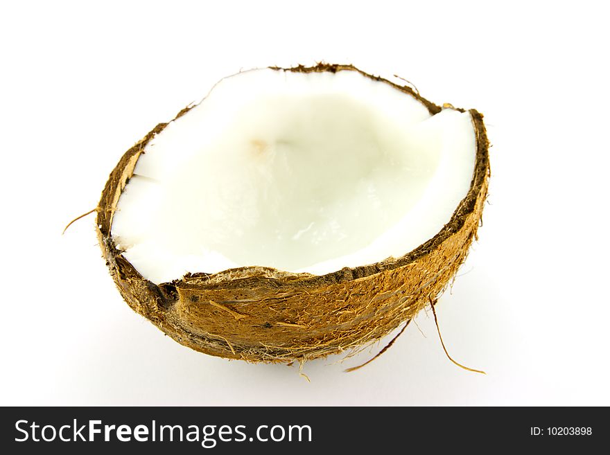 Half a brown hairy coconut on a white background. Half a brown hairy coconut on a white background