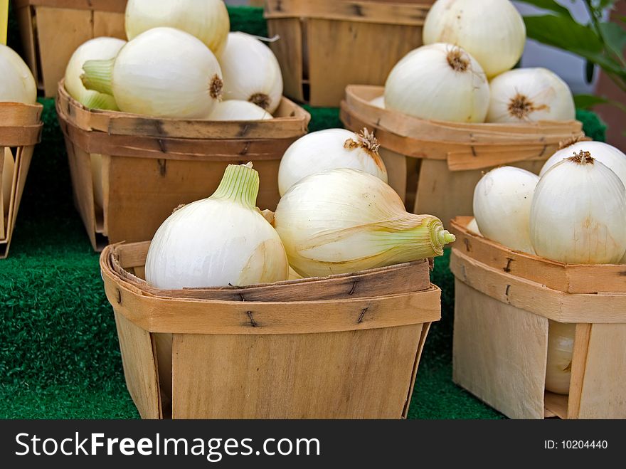 White onions in produce boxes. White onions in produce boxes.