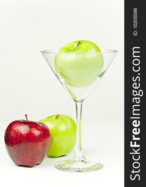 A Martini glass with an apple inside. A Martini glass with an apple inside
