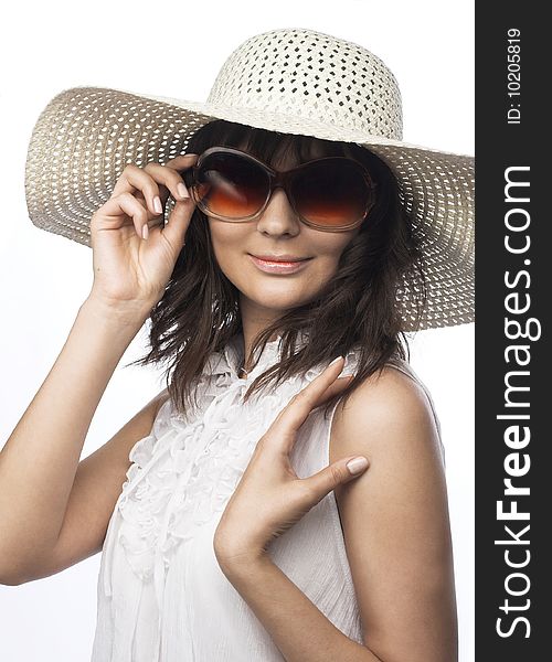 Romantic portrait of young woman in white hat and big sunglasses