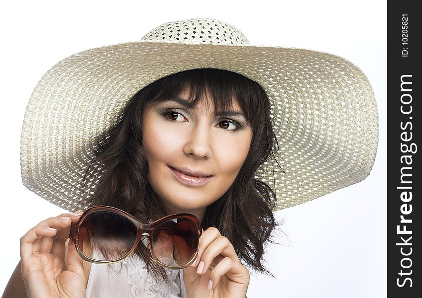 Romantic portrait of young woman in white hat with big sunglasses