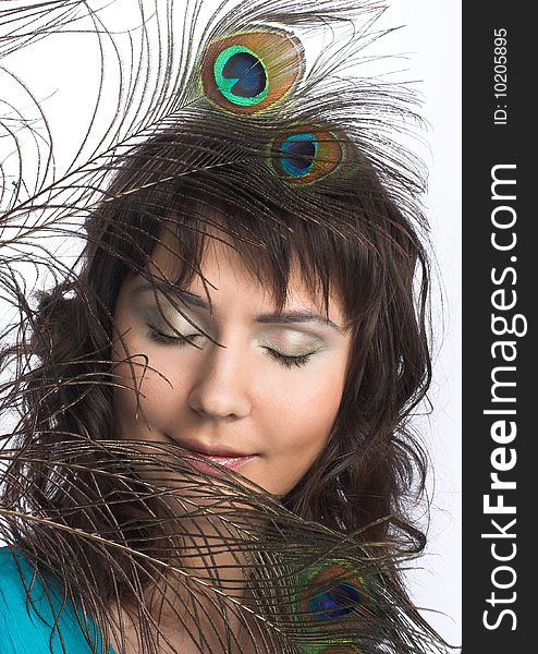 Portrait of young woman with peacock feathers. Portrait of young woman with peacock feathers