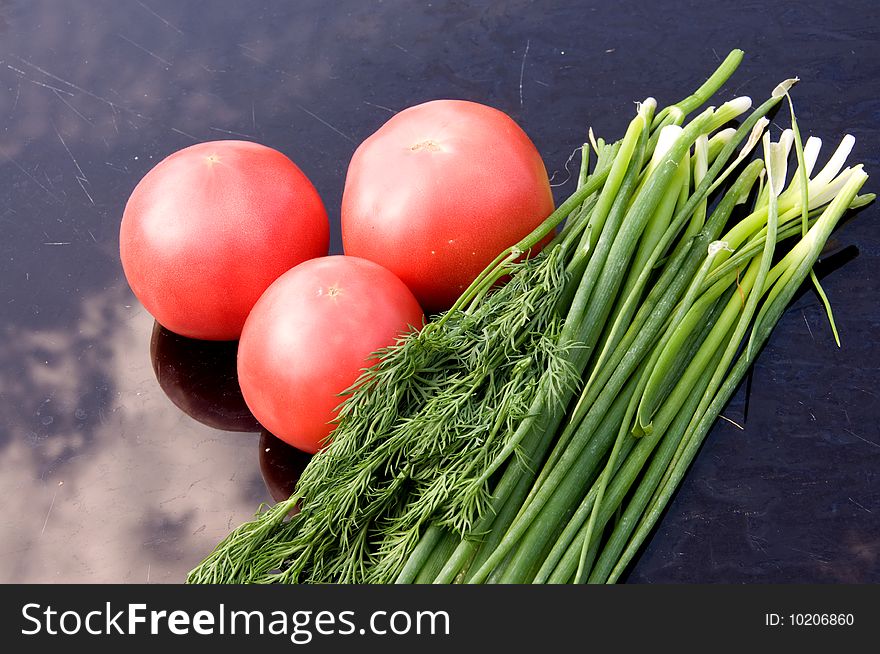 Tomatoes, onions and dill on the table