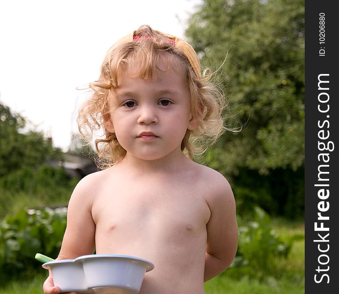 Little girl eating in the garden