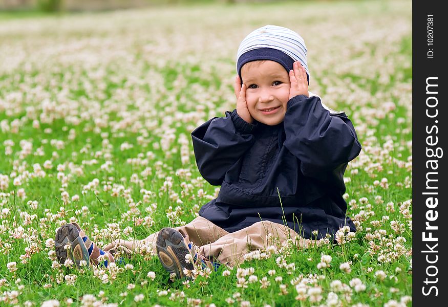 Surprised Caucasian Boy In a Field Full Of Clover Flowers. Surprised Caucasian Boy In a Field Full Of Clover Flowers