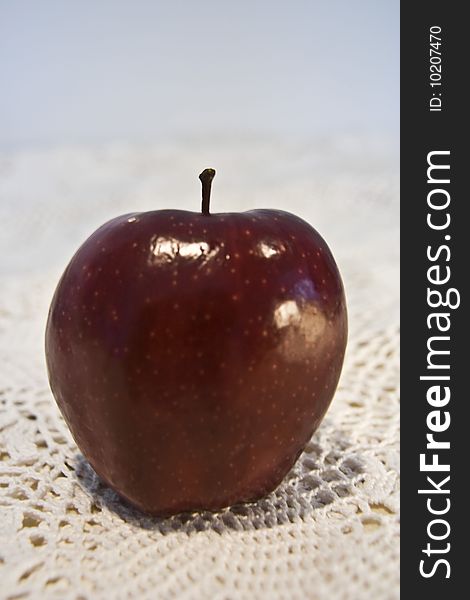 Red delicious Apple on lace table top.