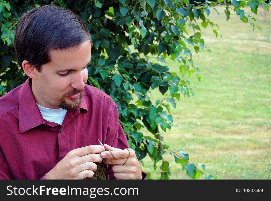Man Knitting With Tree
