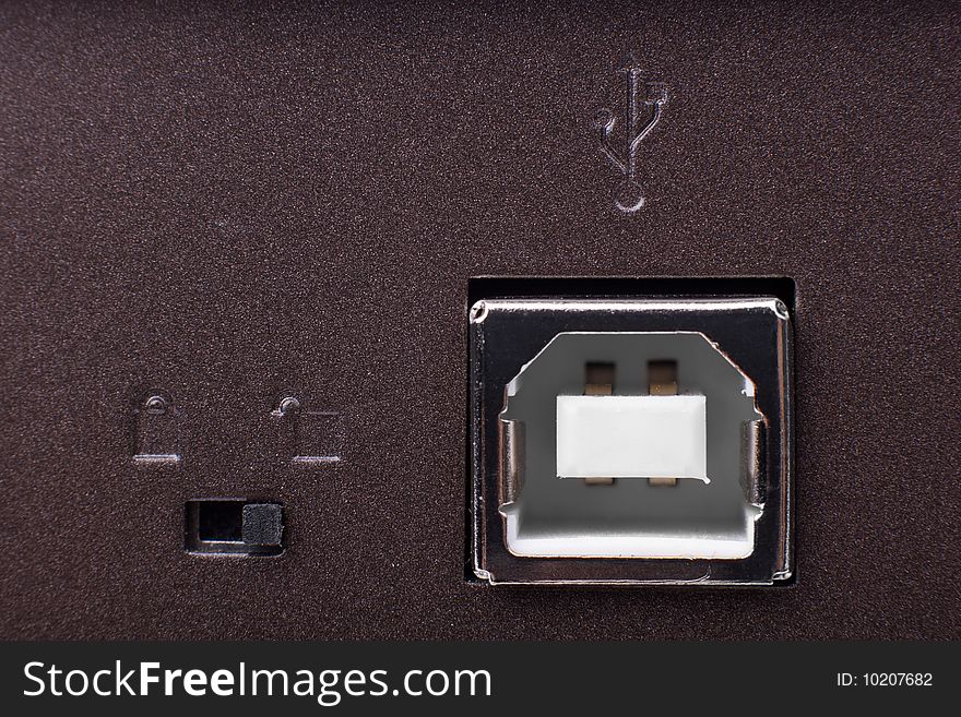 USB slot - macro shot on brown metal surface