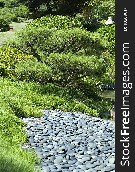 Image taken of a garden with a rock bed next to a dam. Image taken of a garden with a rock bed next to a dam