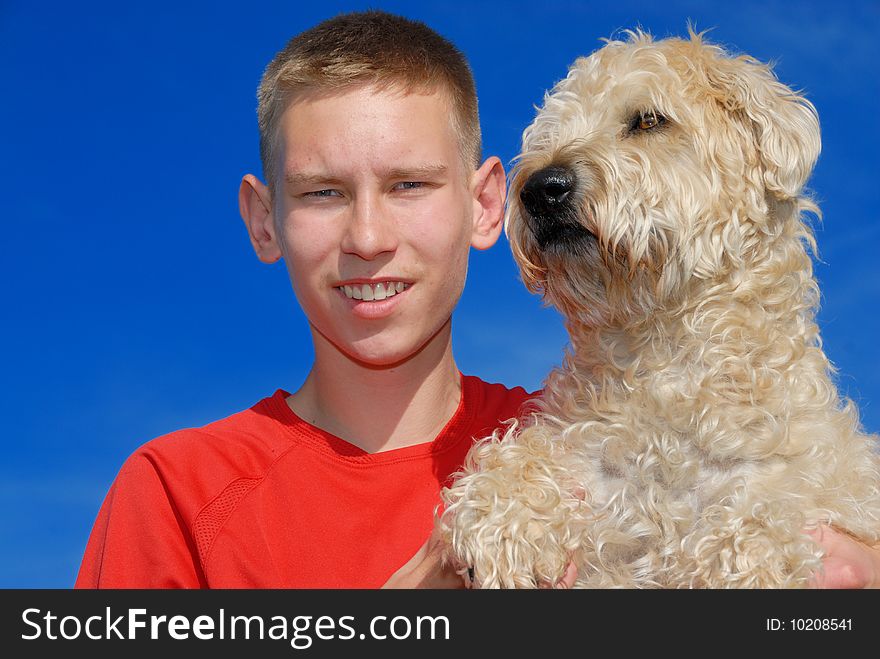 Young men with his wheaten terrier. Young men with his wheaten terrier.