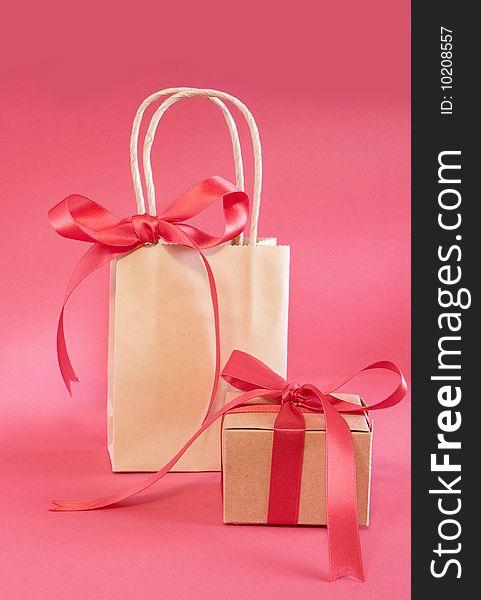 Red bows on craft paper bag and gift for christmas. Red bows on craft paper bag and gift for christmas