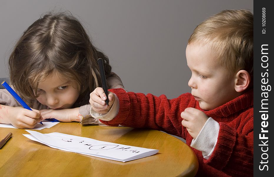 Little boy and girl drawing a picture together