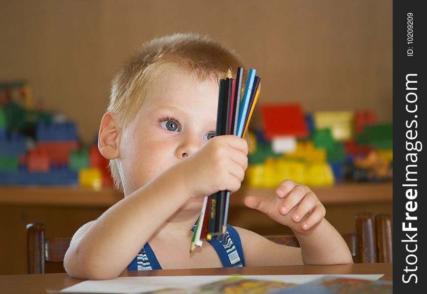 The boy of 2 years is engaged in a children's room