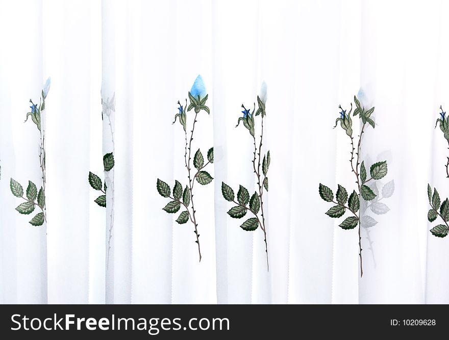 Picture of luxurious curtains with blue roses.