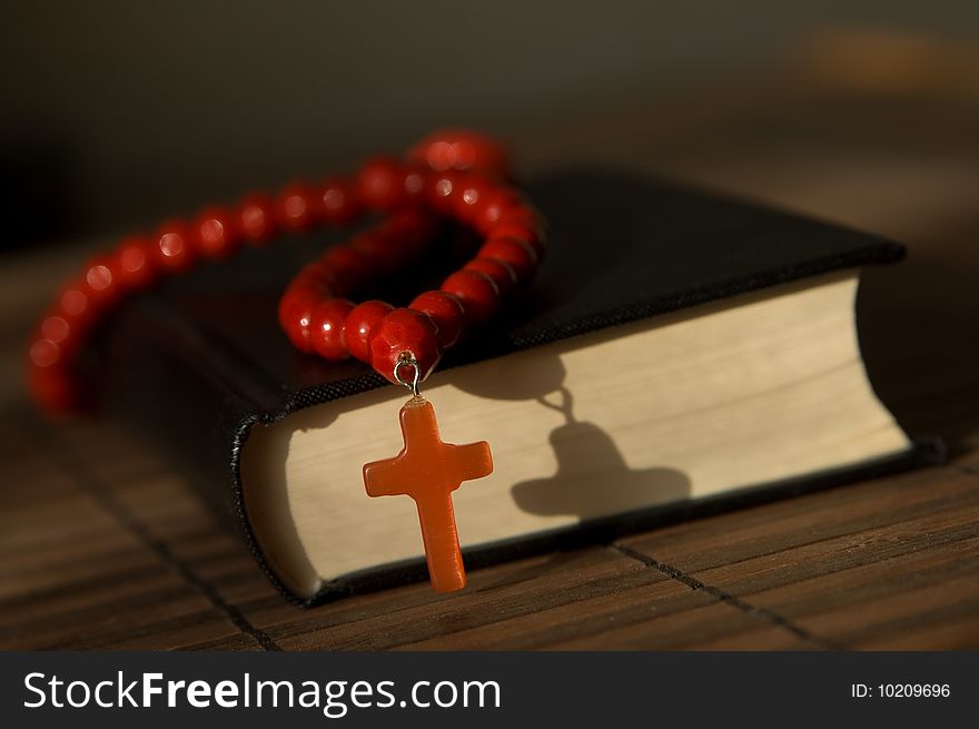 Book and red beads with cross. Book and red beads with cross