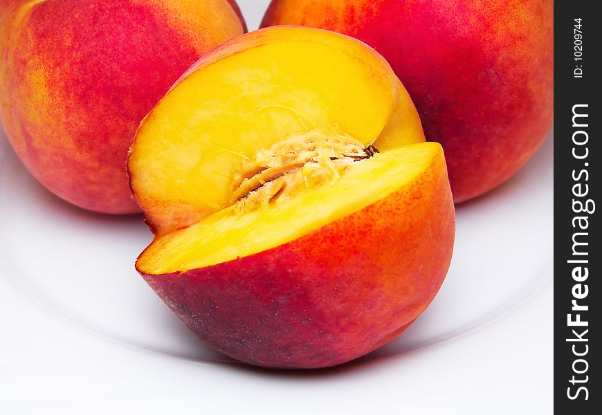 Three juicy peaches isolated white