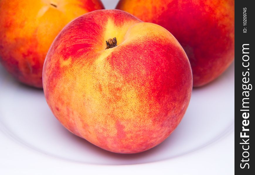 Three juicy peaches isolated white