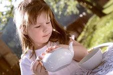 The Beautiful  Little Girl Pours Hot Tea Royalty Free Stock Photos
