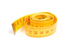 Curled Yellow Measuring Tape On White Stock Images