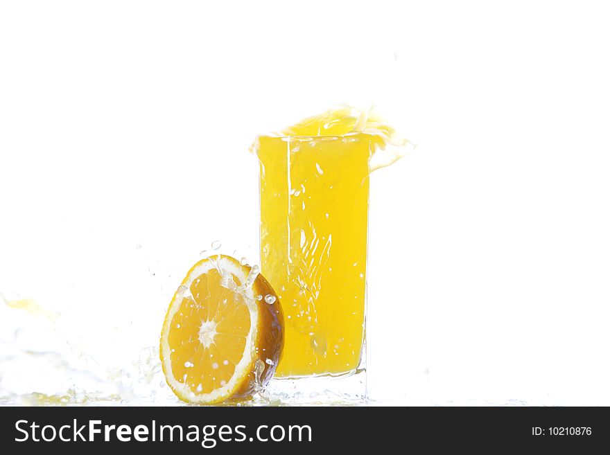 Oranges and glass of cold juice under splash. Oranges and glass of cold juice under splash
