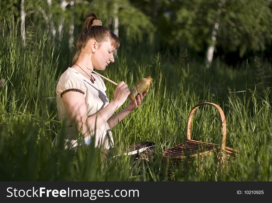 Pregnant woman sitting on grass and drawing bowl. Grecian style. Pregnant woman sitting on grass and drawing bowl. Grecian style.