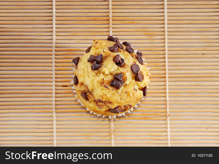 Isolated chocolate chips vanilla baked muffin. Isolated chocolate chips vanilla baked muffin