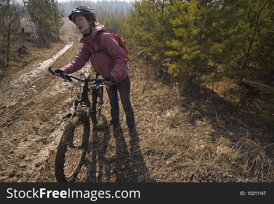 Woman-biker standing and plan pathway. Woman-biker standing and plan pathway.