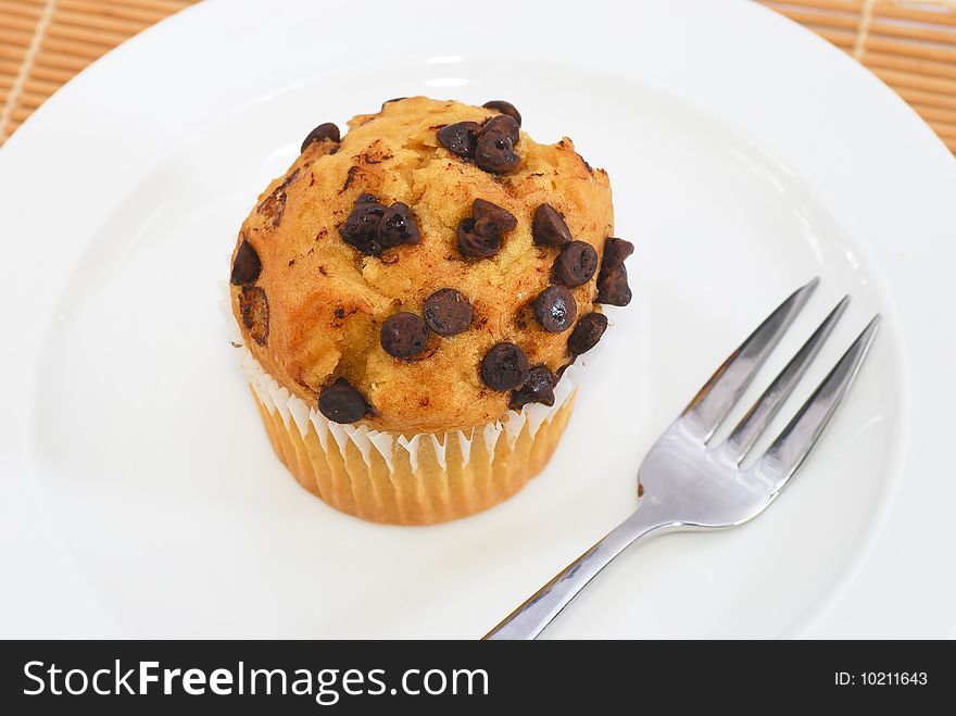 Isolated Chocolate Chips Vanilla baked muffin on plate. Isolated Chocolate Chips Vanilla baked muffin on plate