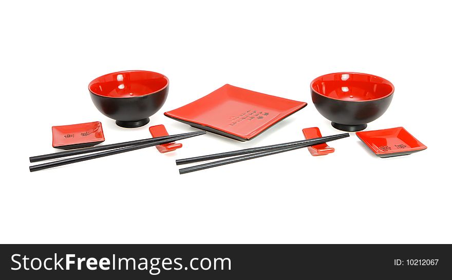 Red and black Japanese sushi service for two isolated
