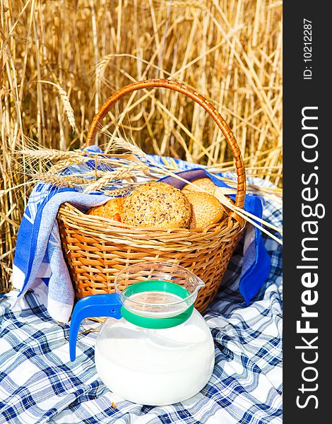 Bread in a wicker basket and milk jug. Bread in a wicker basket and milk jug