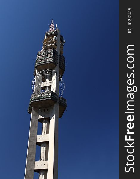 Large microwave tower build from concrete against a blue sky. Large microwave tower build from concrete against a blue sky