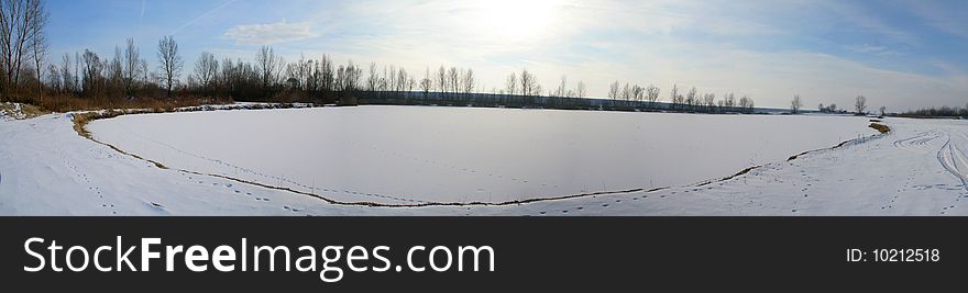 Panorama of frozen lake in the winter