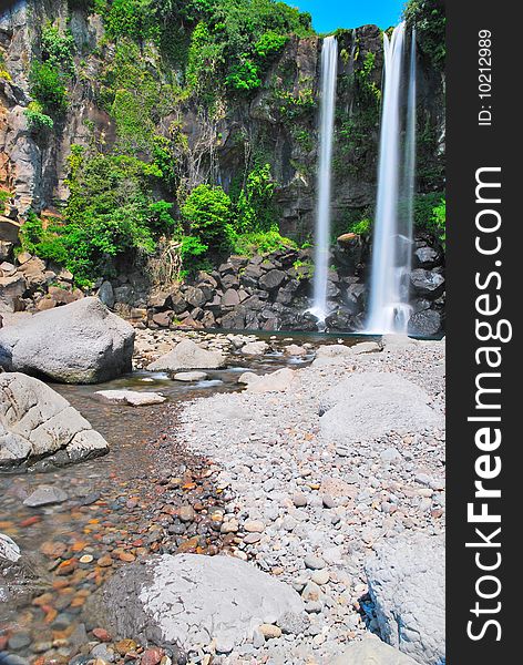 Low shot of majestic waterfall with sky background