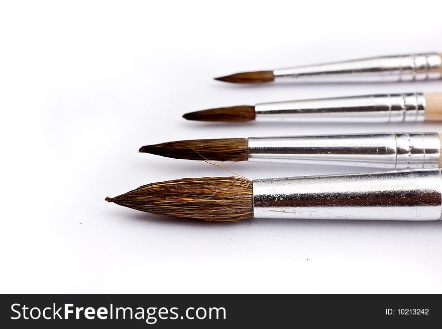 Paintbrushes in various sizes (shallow depth-of-field, selective focus on first brush)