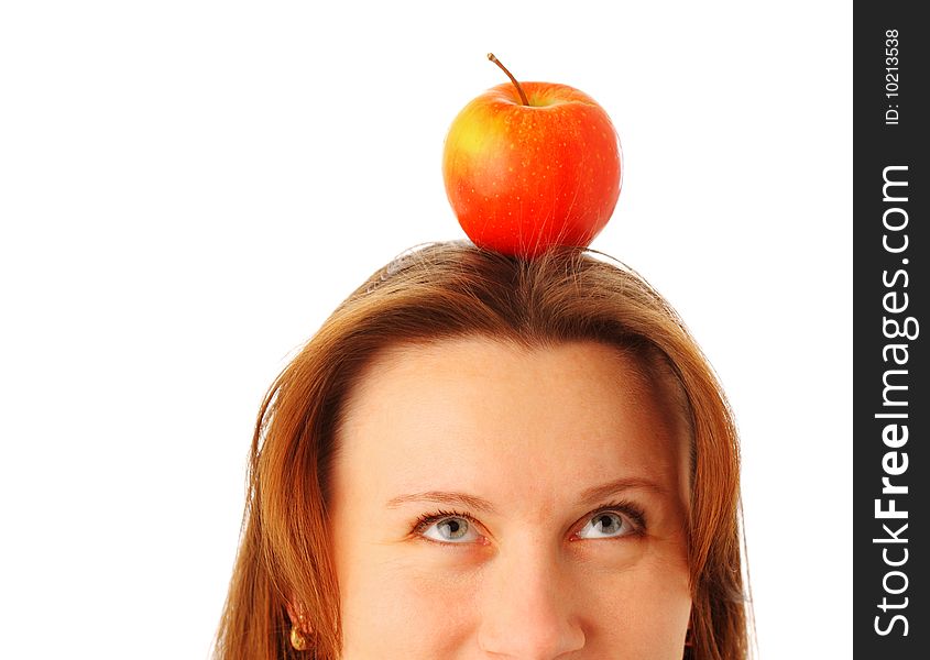 Cropped image of a young attractive woman with a juicy red apple on her head, isolated over white background. Cropped image of a young attractive woman with a juicy red apple on her head, isolated over white background