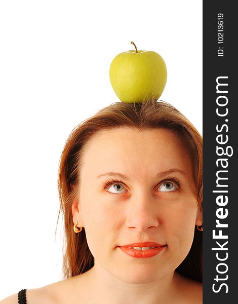 Closeup portrait of a young attractive woman with a juicy green apple on her head, looking up and smiling, isolated over white background. Closeup portrait of a young attractive woman with a juicy green apple on her head, looking up and smiling, isolated over white background