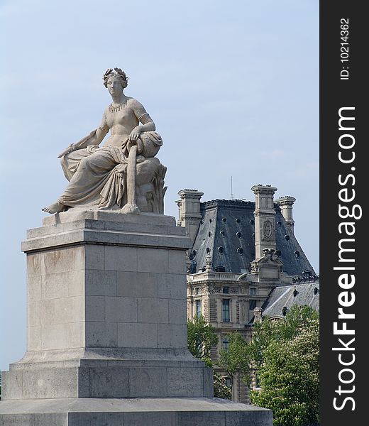 Statue on the Seine, the Conciergerie on the back. Statue on the Seine, the Conciergerie on the back