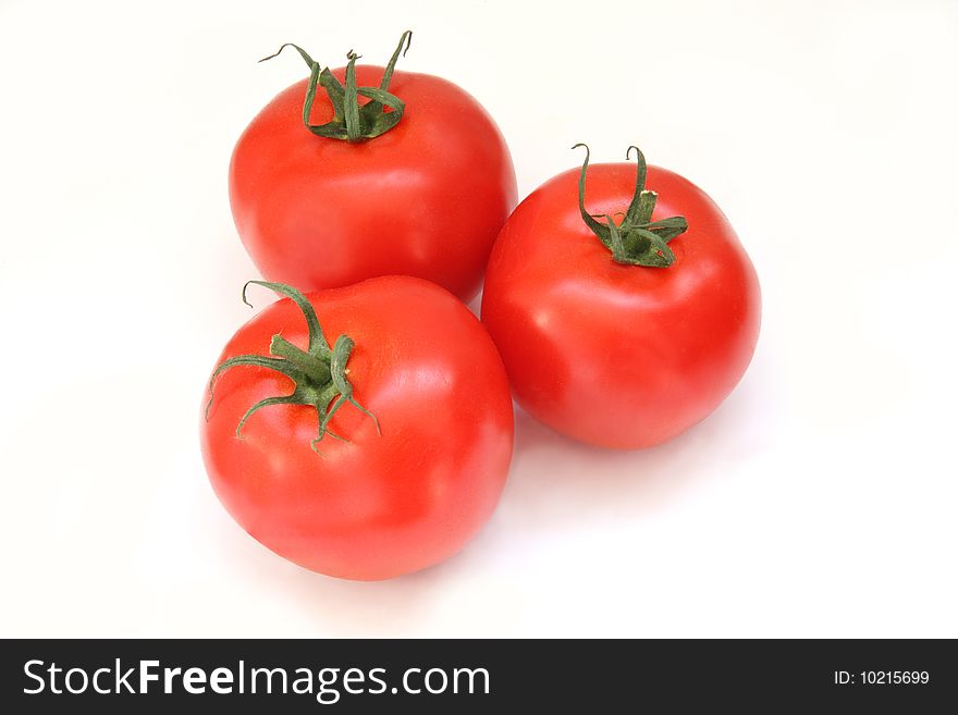 Three ripe tomatoes isolated on a white background. Three ripe tomatoes isolated on a white background