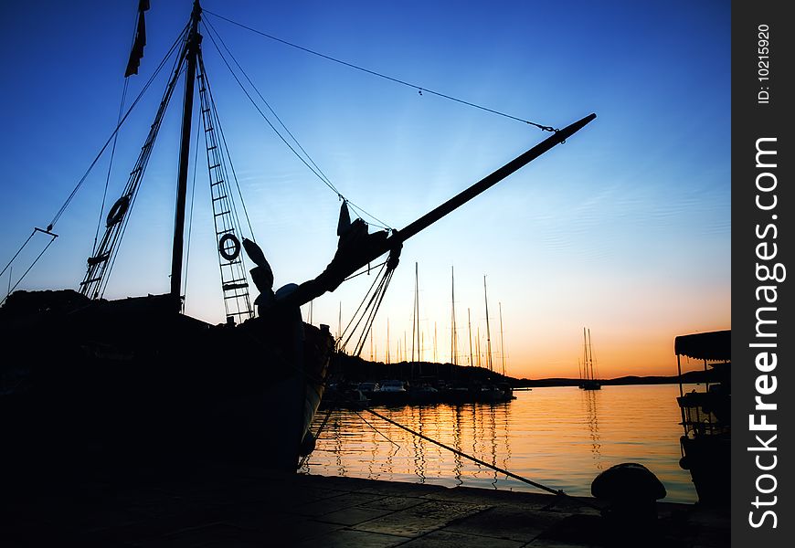 Silhouette of a retro ship in the Adriatic port in the quiet and tranquil  evening.