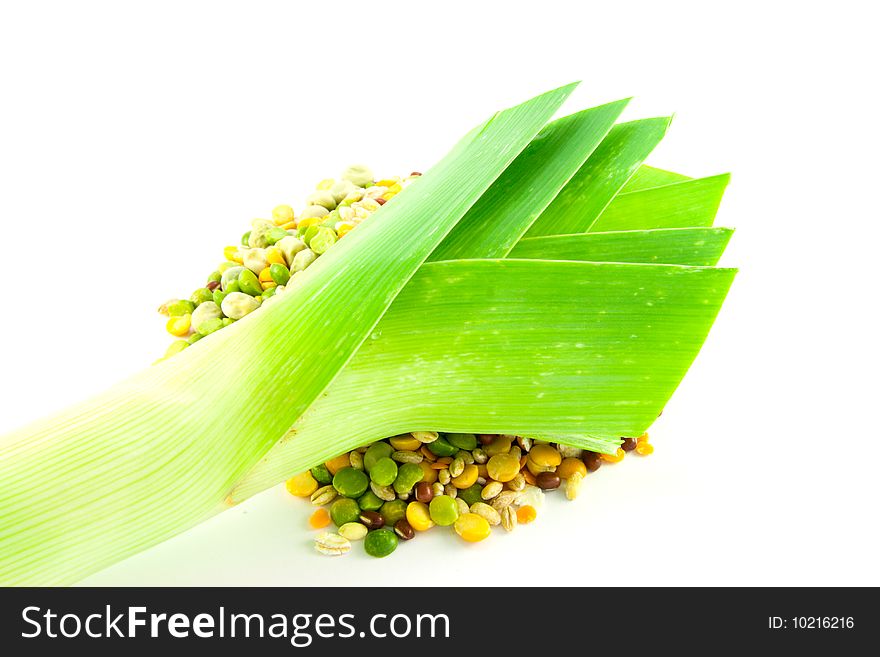 Assorted soup pulses in a heap with a leek on a white background. Assorted soup pulses in a heap with a leek on a white background